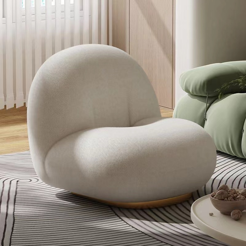 Sculptural cream lounge chair in a warm interior